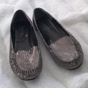 Grey, slip-on shoes with a textured pattern.
